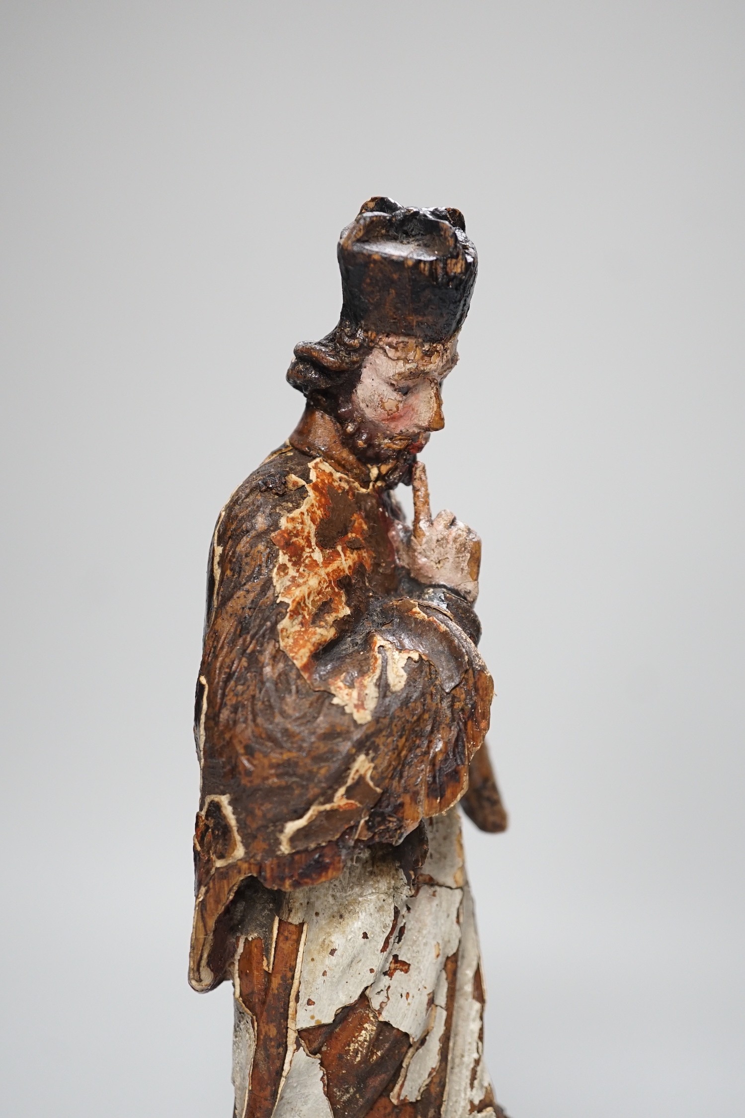 An 18th/19th century Continental carved wooden polychrome figure of saint, 33cms high